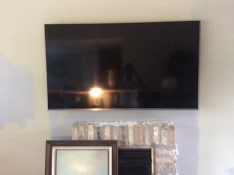 TV Mounted on Wall over Fireplace