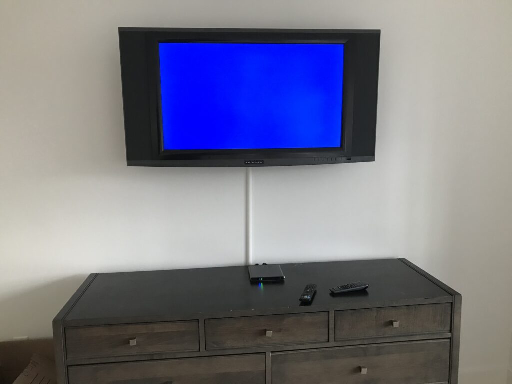65 TV mounted on the wall with wiring in plastic molding