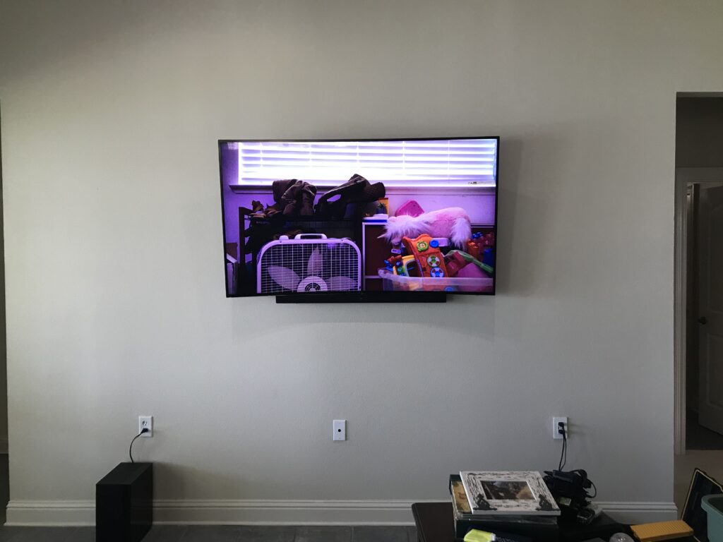 70 TV Mounted on wall with wiring concealed in wall