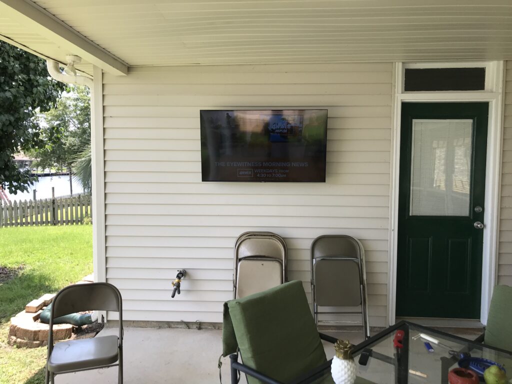 50 TV Mounted on the exterior of the home wall with wiring concealed in wall