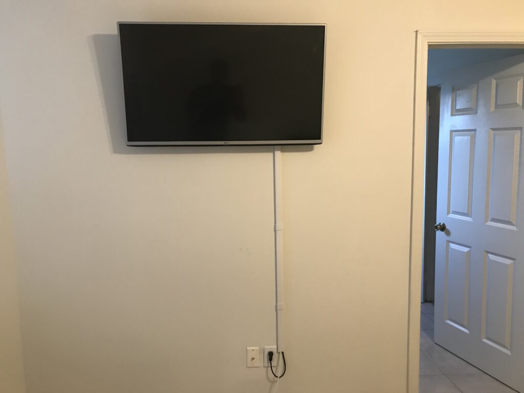 55 TV Hung using a tilt mount wires concealed in molding