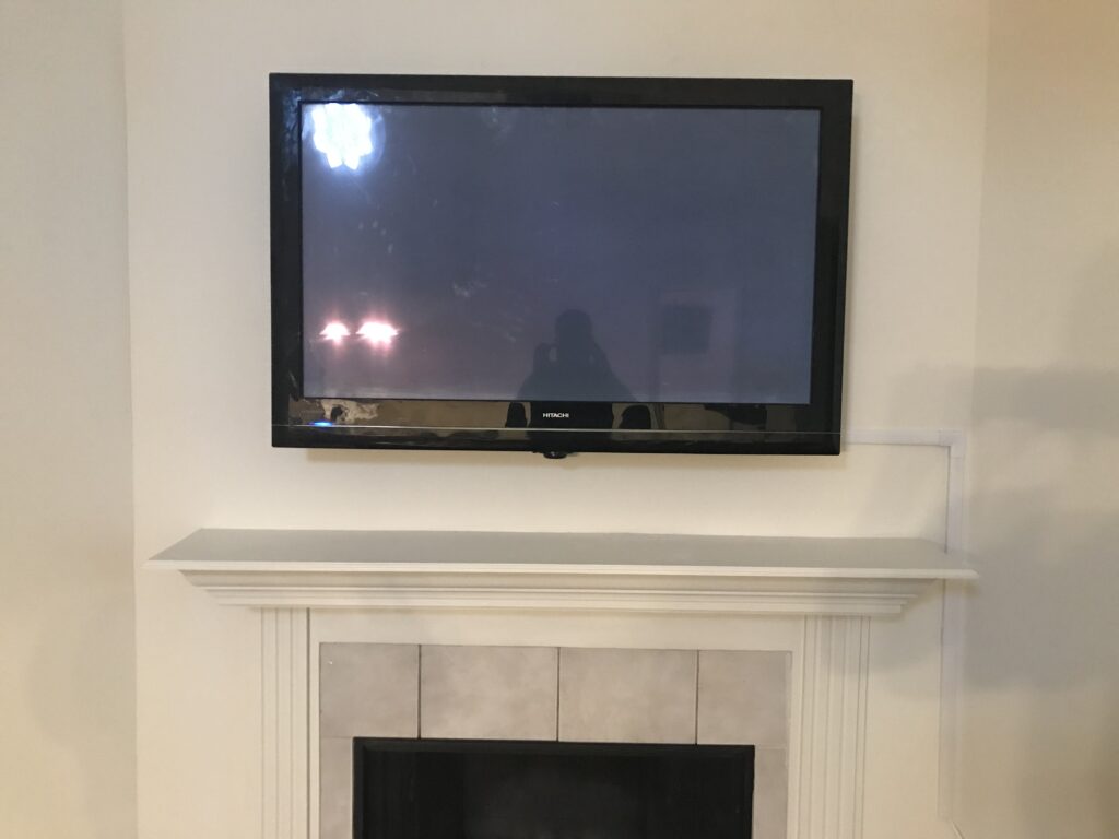 TV over Fireplace with wires hidden in molding